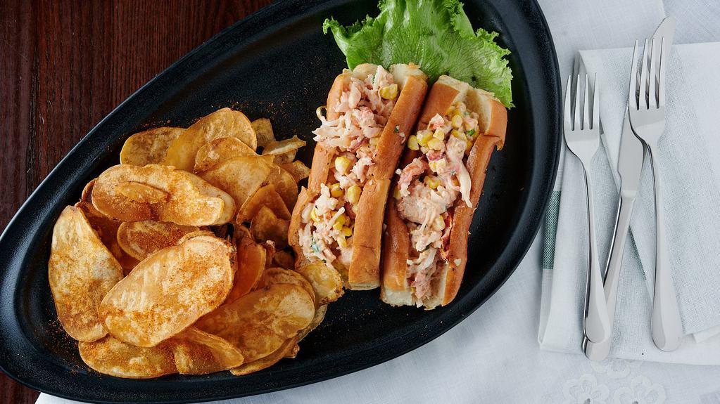 Lobster Rolls · Maine lobster with sautéed corn, grilled tomatoes, herbs, and our signature sauce on new England style rolls; served with bay chips.