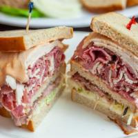 Super Deluxe Triple Decker · Corned beef, roast beef, and turkey with Russian dressing and cole slaw.