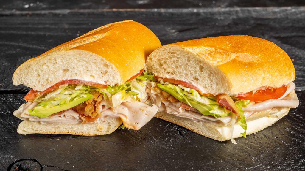 California Turkey Club Sandwich · Turkey, avocado, bacon, lettuce, tomato, and mayo.