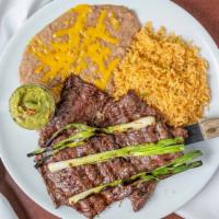 Carne Asada · Charbroiled skirt steak served with guacamole and grilled green onions.