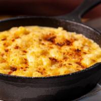 Baked Mac + Cheese · Aged cheddar cheese, breadcrumbs
