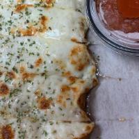 Cheesy Bread Strips · Mozzarella cheese over oven baked bread strips, served with marinara dipping sauce.