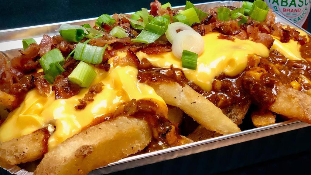 Chili Cheese Fries · Fries absolutely overloaded with House Chili, Cheesy Sauce,  Smoked-Out Aioli, Bacon Crumble, and Scallions.
