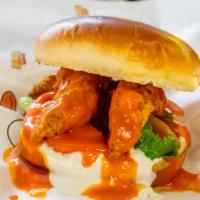 The Blue Torpedo · Quarter pound of handcrafted chicken tenders, lettuce, tomatoes, buffalo sauce and blue chee...