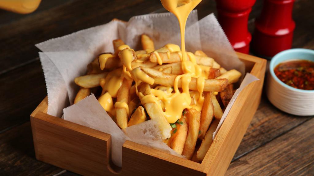 Cheese Fries · Fresh batch of french fries loaded with melted cheese on top.