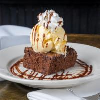 Homemade Brownie · Served with vanilla ice cream, whipped cream and chocolate drizzle.