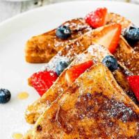 French Toast · Served topped with fresh fruit and maple syrup.