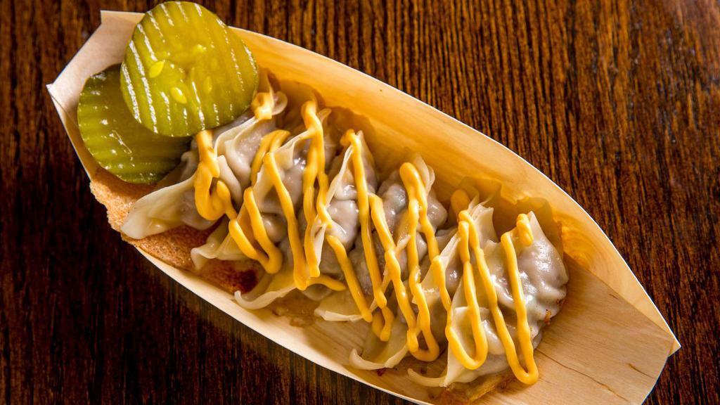 Cheeseburger Dumplings · Six pieces. Ground beef with onions and three cheese blend. Served with a cheese sauce, pickles, and comes with one choice of side.