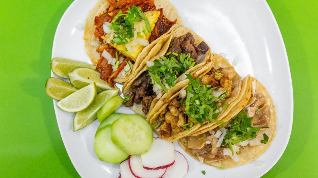 Taco Regular · Corn tortilla tacos with cilantro, onions, lime, radishes, cucumber and choice of salsa on the side.