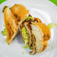 Torta Regular · Mexican sandwich. With choice of meat, mayo, beans spread, tomatoes, avocado, lettuce, mozza...