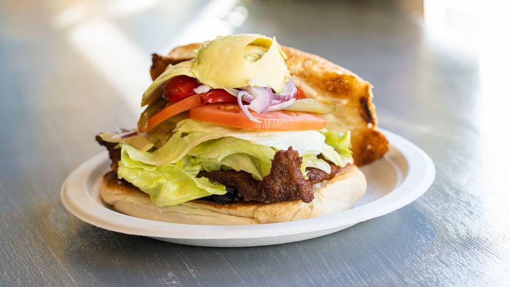 Torta Milanesa De Res · Breaded beef Mexican sandwich. With mayo, beans spread, tomatoes, avocado, lettuce, mozzarella cheese and jalapeños.