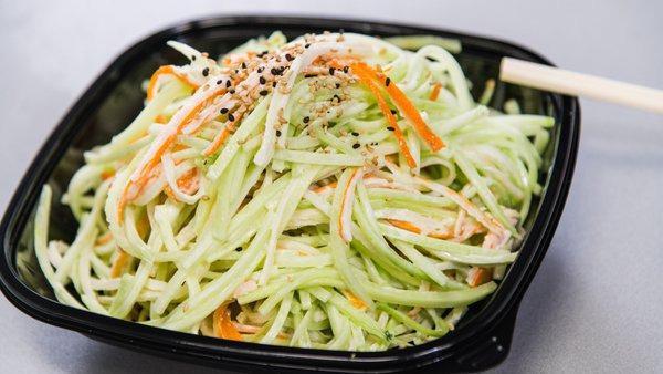 Kani Salad · Shredded kani mixed with thinly shredded cucumber tossed in a light mayo-based dressing.