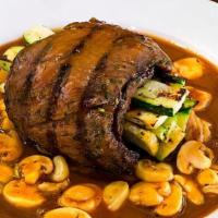 Country Style Skirt Steak · Prime Skirt Steak Grilled and rolled with zucchini squash and topped with our Signature Brow...