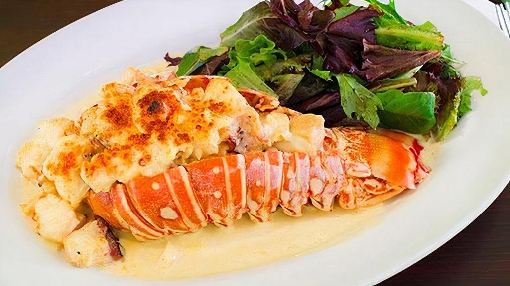 Langosta Lamborghini · Lobster tail stuffed with seafood and topped with grated Parmesan Cheese after been flamed with cream. Served with choice of side and small salad.