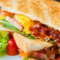 Hungry Man Breakfast Sandwich · Your choice of toasted bread, melted cheese, egg preparation, crispy bacon, savory Italian s...