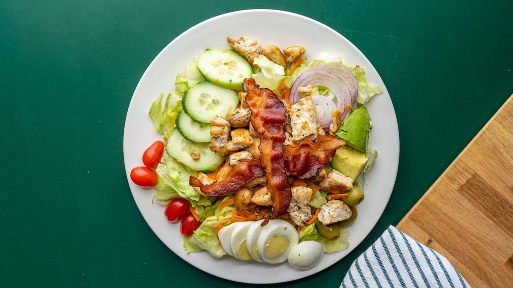 Cobb Salad · Mixed greens, tomatoes, onions, cucumbers, green olives, carrots, hard boiled egg, grilled chicken, bacon, avocado and side of blue cheese.