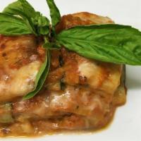 Parmigiana Di Melanzane · Baked eggplant layered with mozzarella and Parmigiano in tomato sauce.