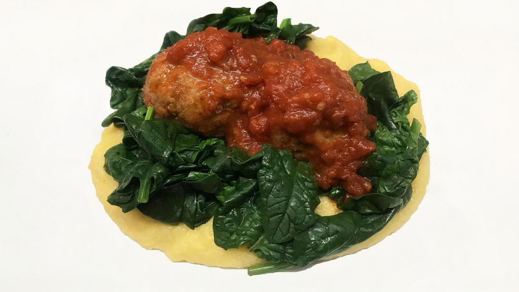Polpette Alla Lucana · Basilicata. Veal meatballs in tomato sauce over soft polenta with wilted spinach.