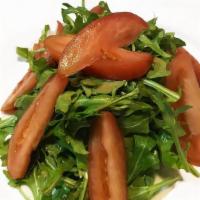 Pomodoro Sulla Rughetta Salad · Apulia. Wild arugula and ripe tomatoes in a shallot and balsamic vinegar dressing.