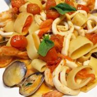 Calamarata Ai Frutti Di Mare · Molise. Short rigatoni with clams, calamari, shrimp and red cherry tomatoes in garlic and wh...