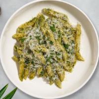Chuck Cluck Pesto Penne · Fresh penne pasta cooked in pesto sauce topped with chicken, black pepper, parsley, and mozz...