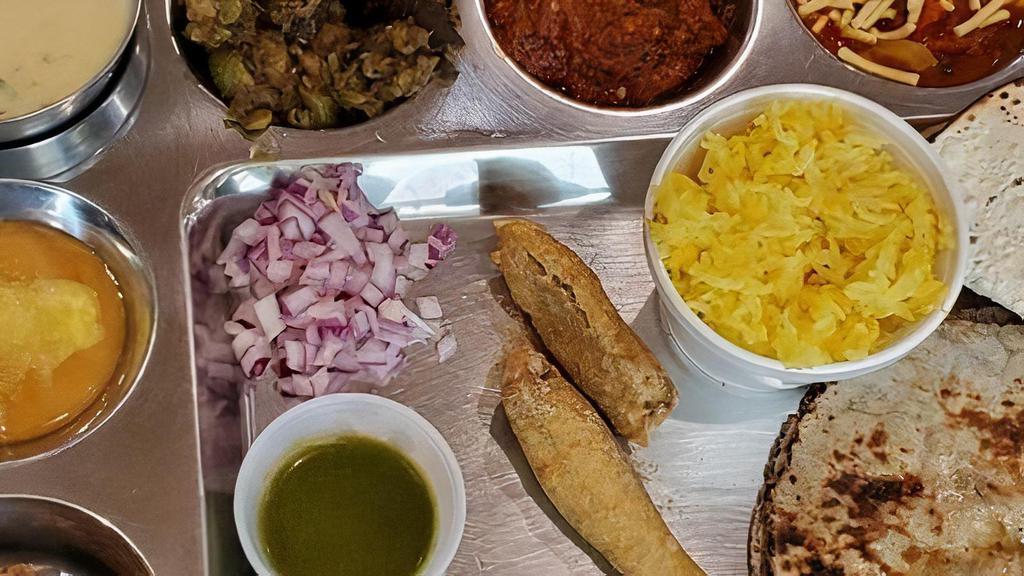 Gujarati Thali · Three vegetables, one farsan, one sweet, daal, rice, papad, pickle, chaas and roti.