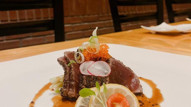 Pepper Tuna Tataki · Sliced seared black pepper tuna with wasabi yuzu sauce, topped with scallion and masago.
