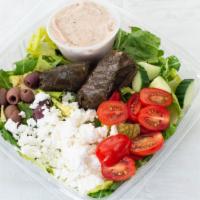 Greek Salad · Romaine and spring mix topped with cucumbers, tomatoes, kalamata olives, grape leaves, and f...