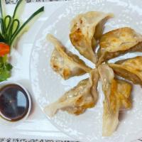 Pan Fried Dumplings · 6 pieces, Pan-fried pot stickers stuffed with seasoned vegetables & pork, served with a spec...