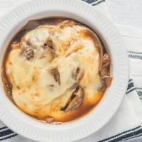French Onion Soup · Topped with melted mozzarella and served in a crock.