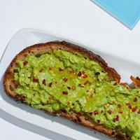 Avocado Toast-Avocado On Whole Wheat Toast Topped With Red Chili Flakes, Sea Salt And Olive Oil. · Smashed avocado on whole wheat toast topped with red chili flakes, cracked sea salt and oliv...