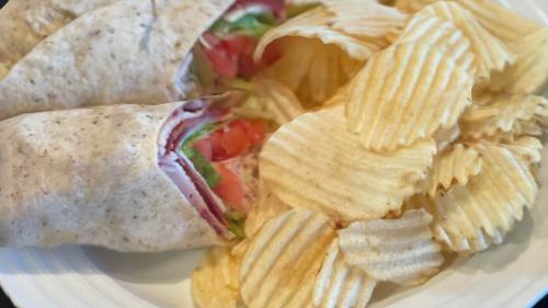 Club Wrap · Fresh sliced turkey, 2 pieces Applewood bacon, lettuce, tomatoes, Swiss cheese, mayo wrapped in an herb tortilla.