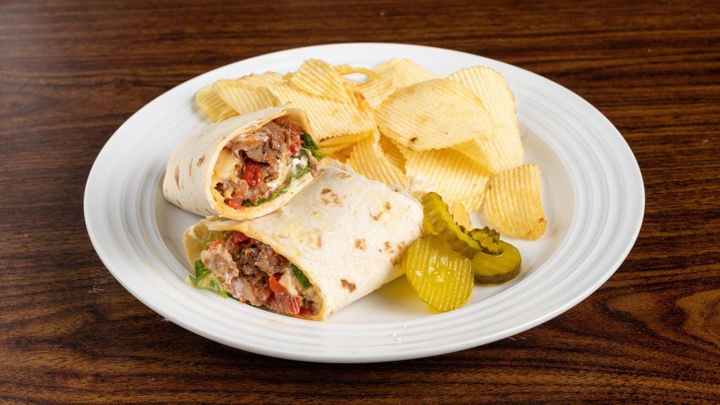 Steak Wrap · Fresh seared steak sautéed peppers and onions served over lettuce, tomatoes finished with horseradish, mayo in a herb tortilla.