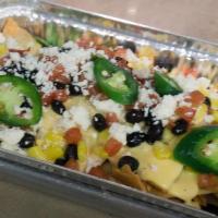 Fiesta Nachos · fresh fried tortilla chips topped with house-made cheese sauce, roasted corn, black beans, f...