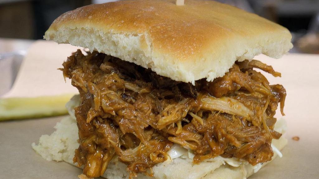 Bbq Pulled Pork · with cole slaw and Fritz's frizzles on our house roll.