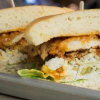 Buffalo Style · smothered in house-made buffalo sauce & topped with your choice of blue cheese crumbles or r...
