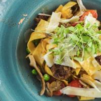 Braised Short Rib Pappardelle · Parmigiano Reggiano, grape tomatoes, peas, oyster mushrooms, shallots and truffle oil in a s...