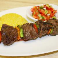 Mediterranean Shish Kebab · Marinated hanger steak with bell peppers, served with couscous and Israeli salad.