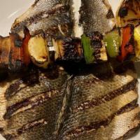 Whole Grilled Branzino · Grilled branzino, butterflied and served with lemon wedge & mixed vegetables.