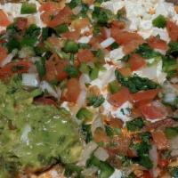 Nachos Spicy Rubbed Pork (Enchilada) · Beans, crispy tortillas, cilantro, onions, tomato, guacamole, sour cream, cotija, cheese, an...