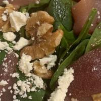 Insalata Di Spinaci · Spinach greens topped with pears, walnuts and goats cheese in port vinaigrette.