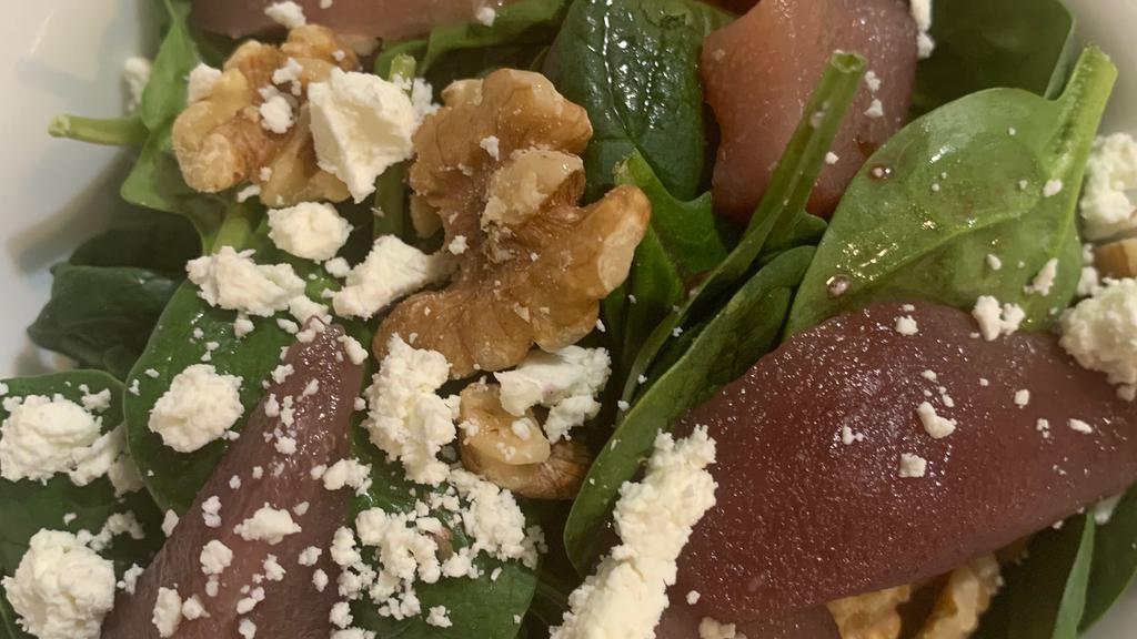 Insalata Di Spinaci · Spinach greens topped with pears, walnuts and goats cheese in port vinaigrette.