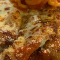 Veal Parmigiana · veal cutlets breaded & fried topped with tomato sauce and mozzarella served with homemade pa...