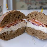 The Garodnick · Whole Wheat Everything Bagel with White Fish Salad & top it off with Swiss Cheese, Onion, To...