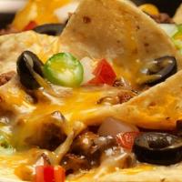 Nachos · Ground beef, cheese, sour cream, lettuce, and tomato.