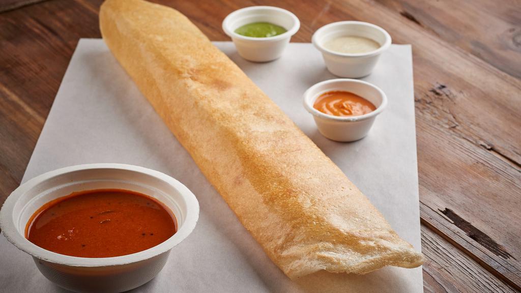 Masala Dosa · Rice and lentil crepe filled with potatoes, onions and spices. 
Served with sambar, coconut - garlic chutney.