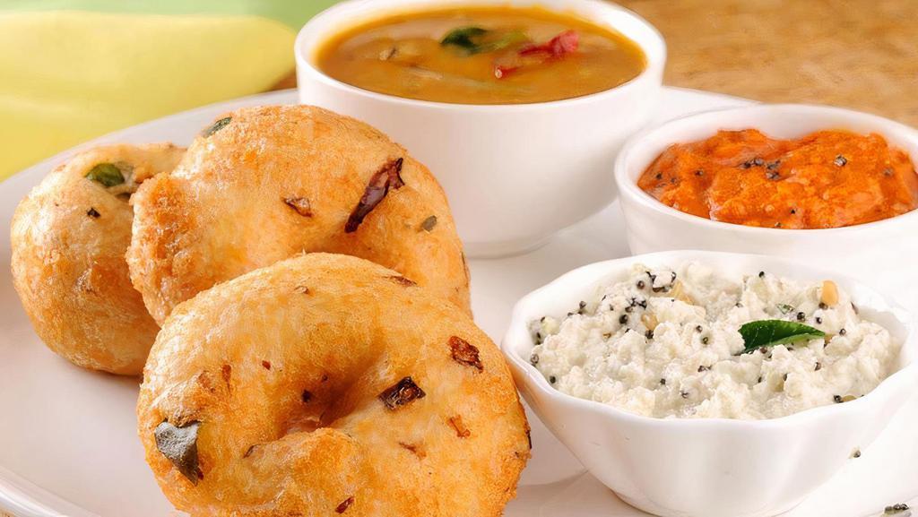 Medu Vada · South Indian fritter in doughnut shape, with a crispy exterior and soft interior.