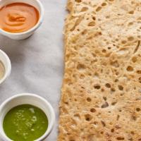 Rava Plain Dosa · Cracked with crepe served with sambar, white - garlic chutney