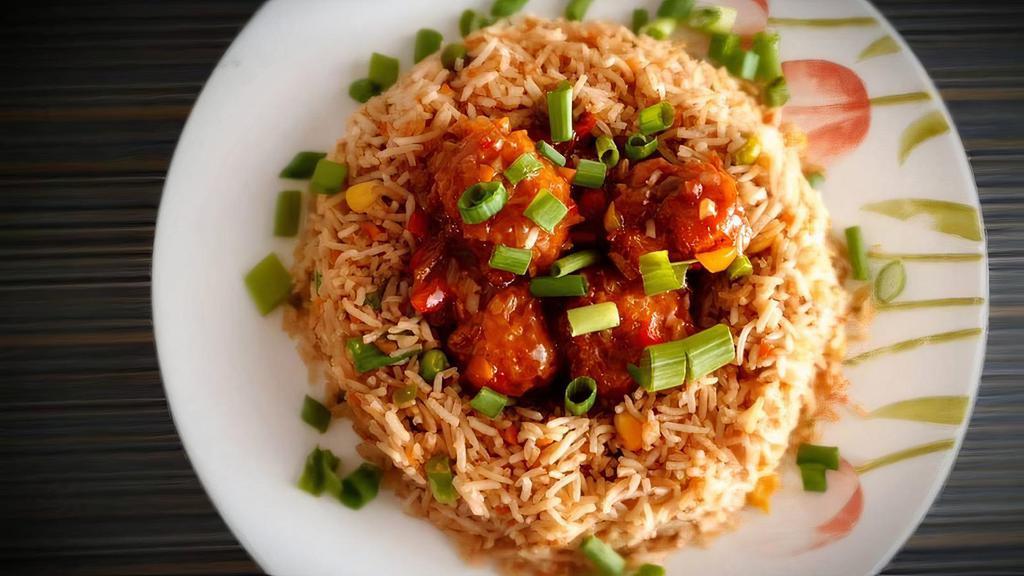 Fried Rice With Manchurian · Fried rice mixed with veg & manchurian balls