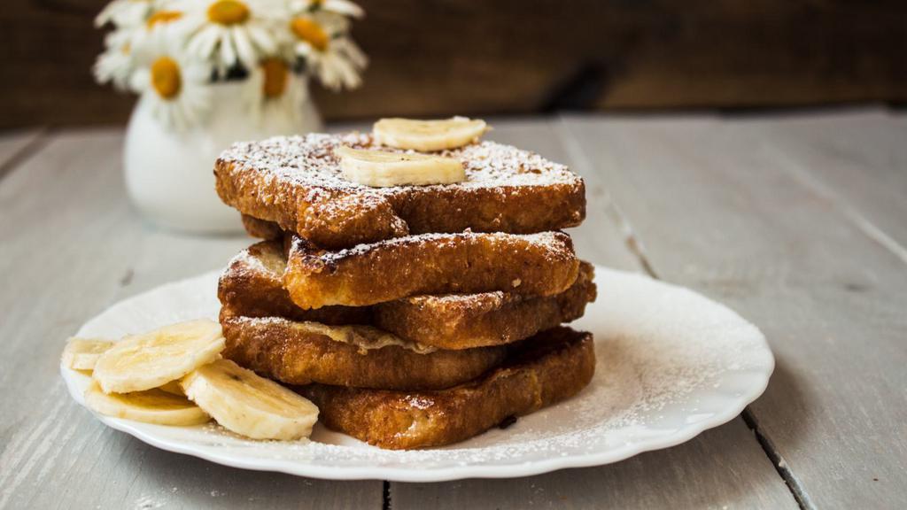 Banana Peanut Butter French Toast · 4 delicious slices of golden French Toast. Topped with Fresh banana slices, peanut butter, a little butter, and served with syrup.